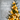 Christmas tree with lights in the background and blurred with a Happy Holidays season's greetings written on the left side of the image. 